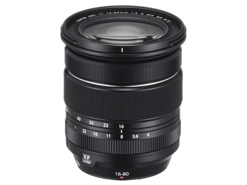 A black Fujifilm XF 16-80mm f/4 camera zoom lens with ridged focus and zoom rings, marked focal lengths, and a clearly labeled aperture ring, standing upright on a white background.