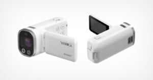 A white Yashica Journey camcorder is shown from two angles, featuring a flip-out screen, lens, control buttons, and compact design on a plain white background.