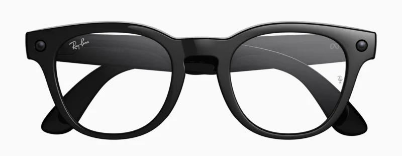 Black Wayfarer-style eyeglasses with clear lenses, featuring the Ray-Ban logo on the upper left lens and thick frames with rounded edges, displayed on a white background.