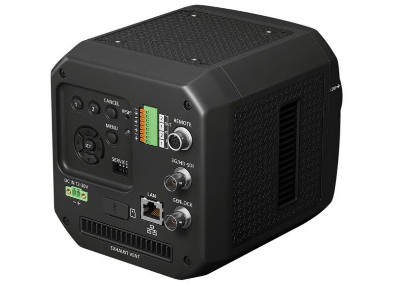 A black, box-shaped electronic device with various ports, buttons, dials, and labels on its visible side; includes connectors for LAN, SDI, remote, and power input. The surface has vented and textured panels.