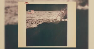 A vintage photo shows the American flag planted on the Moon’s surface, with part of a lunar module visible on the right. The barren, rocky lunar landscape stretches into the background under a black sky.