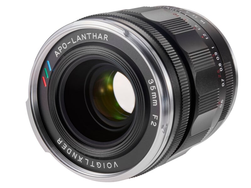 A close-up view of a Voigtländer APO-LANTHAR 35mm F2 camera lens, showing the lens glass, focusing ring, and engraved text on the metal barrel.