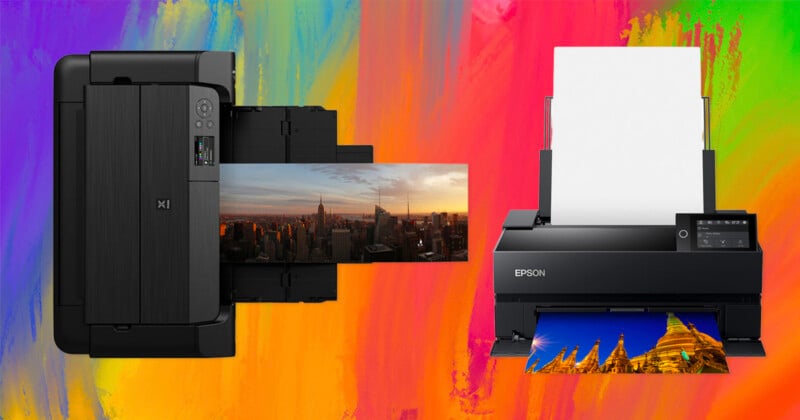 Two photo printers, one black Kodak printer on the left and one black Epson printer on the right, print colorful landscape images against a vibrant rainbow-colored background.
