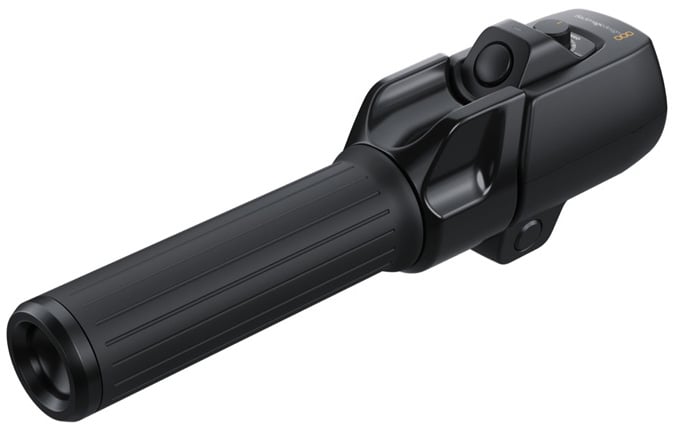 A black handheld electronic device with a ribbed cylindrical handle and a control button on top, resembling a baton or tool, photographed on a white background.