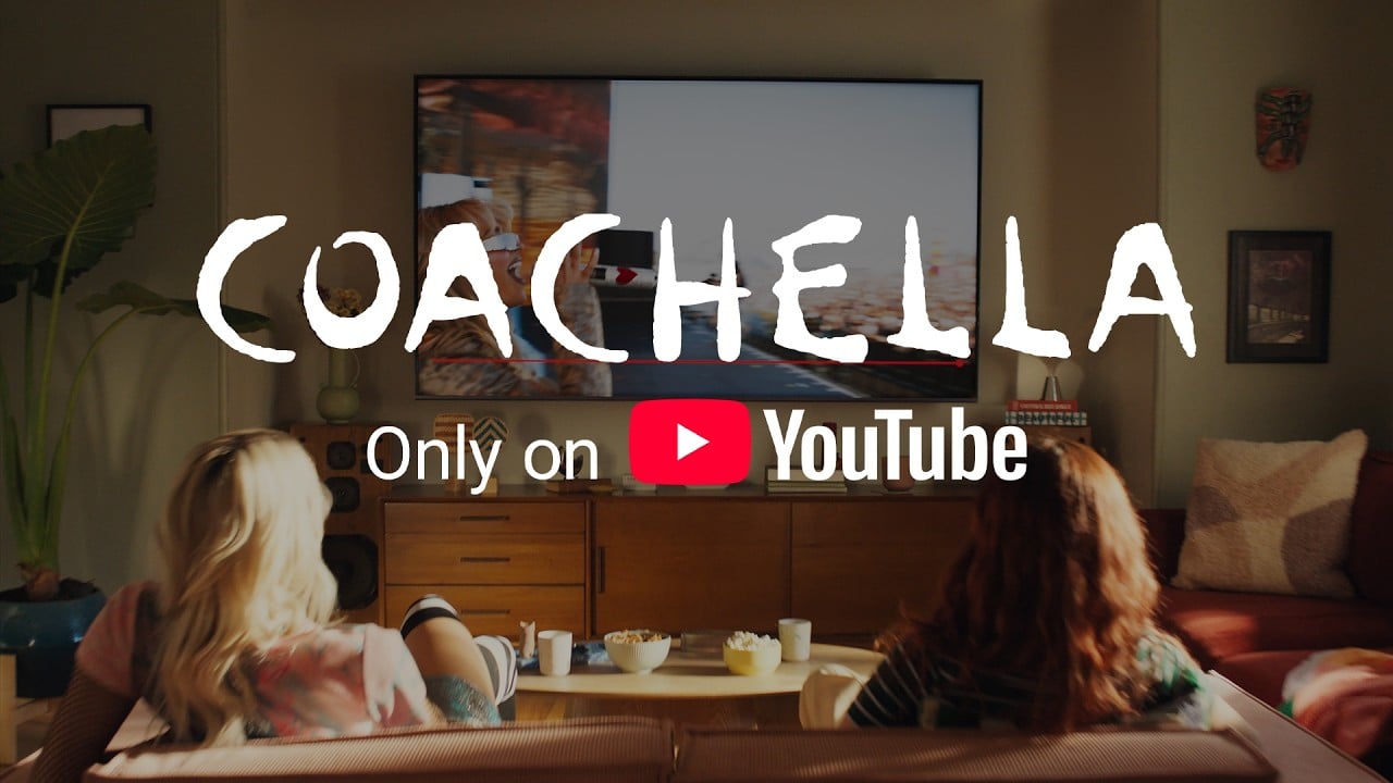 Two people sit on a couch watching a TV screen in a cozy living room. Large text on the image says, "Coachella Only on YouTube," with the YouTube logo displayed.
