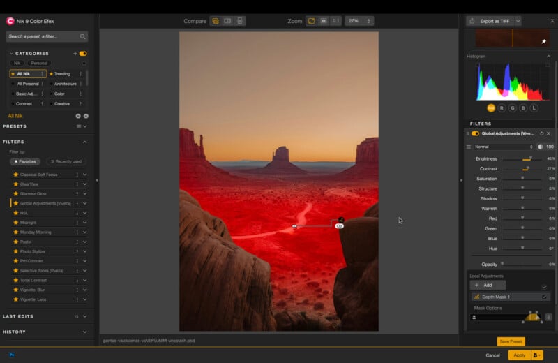 Photo editing software interface displaying a red-tinted landscape of Monument Valley at sunset, with editing tools, adjustment sliders, and a histogram visible around the image.