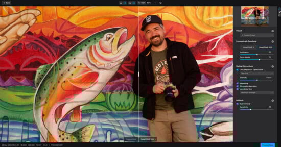 A smiling man in a cap holds a camera and stands beside a colorful mural of a leaping fish, with a photo editing program open showing adjustments on the right.