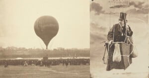 A vintage photo shows a hot air balloon lifting off before a large crowd. Beside it, a man in a suit and top hat sits in a balloon basket, holding sandbags, against a cloudy sky.