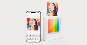 A smartphone displays a photo editing app with a picture of a smiling woman and a dog. Next to it, a compact Polaroid printer is printing the same photo. The devices are on a plain white background.