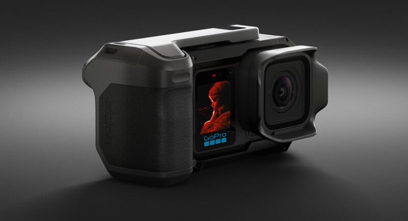 A close-up view of a GoPro action camera with a rugged, black exterior. The camera’s front screen displays a red-toned image of a person, and the GoPro logo is visible below the screen. The background is dark and minimal.