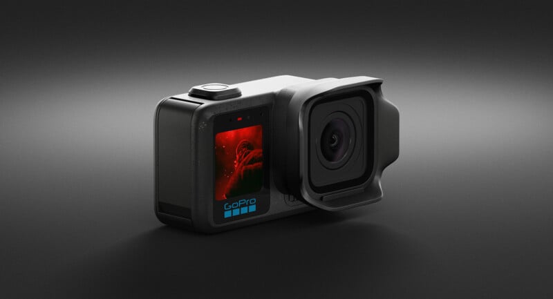A GoPro action camera with a large lens and a small front display screen showing a red-toned image, set against a dark, gradient background.