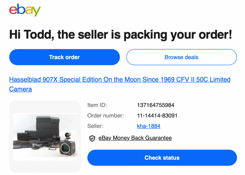 EBay order confirmation for a Hasselblad 907X Special Edition camera. The image shows the camera, accessories, and box arranged on a white surface with blue order tracking and browse deals buttons above.