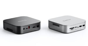 Two compact square devices, one black and one silver, are shown side by side. Both have various ports on their sides, including USB, Ethernet, and audio jacks. The brand "ORICO" is visible on top of each device.