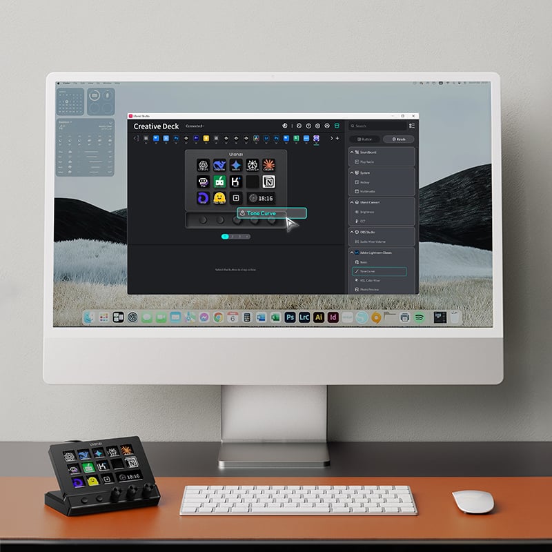 A desktop computer displays software for customizing a control deck, which sits beside a keyboard and mouse on an orange desk. The screen shows icons being arranged in the software interface.
