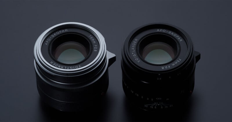 Two Voigtländer camera lenses, both labeled "APO-SKOPAR 35mm F2.8," are positioned side by side on a dark surface. One lens has a silver ring, and the other has a black ring.