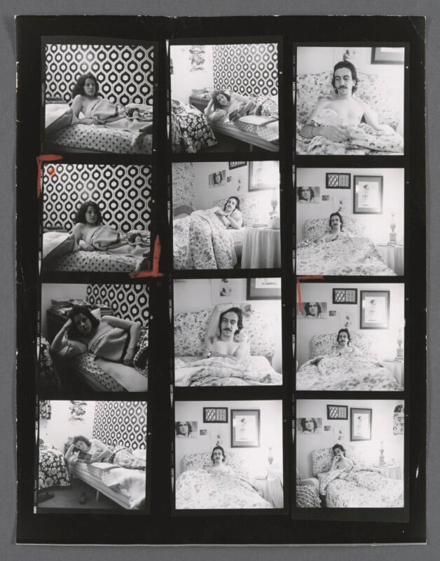A black-and-white contact sheet shows twelve photos of a mustached man with long hair in bed, posing in different ways in a patterned room with framed pictures and floral bedding.