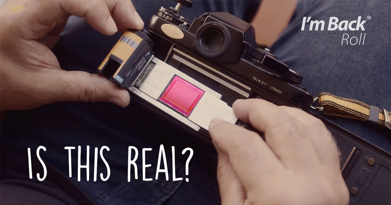 A person inserts a pink digital sensor into a vintage Nikon film camera. The text "I'm Back Roll" and "Is This Real?" appear over the image.