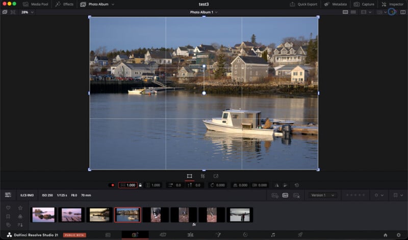 A screenshot of DaVinci Resolve software showing an image of boats on calm water with houses on a hillside in the background. The image is being edited, with cropping guides and adjustment tools visible.