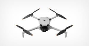 A white quadcopter drone with four black propellers and a front-facing camera, shown against a plain white background.