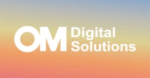 White text reads "OM Digital Solutions" on a gradient background blending blue, yellow, and orange shades.