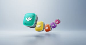 Four colorful, cube-shaped DJI devices in teal, yellow, purple, and orange, appear to float in a row against a soft, gradient background. Each cube has the DJI logo prominently displayed.