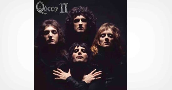 Four people in dark clothing pose dramatically against a black background, with two in back and two in front. The top left corner features the text "Queen II" in a stylized font.