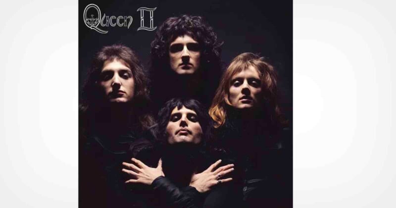Four people in dark clothing pose dramatically against a black background, with two in back and two in front. The top left corner features the text "Queen II" in a stylized font.