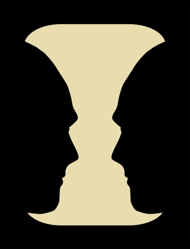 Optical illusion showing two black silhouettes of faces in profile, facing each other, which also forms the shape of a beige hourglass or vase in the space between them.