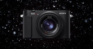 A Sony RX1R camera with a Zeiss lens is shown centered against a dark background with white specks resembling falling snow or stars.