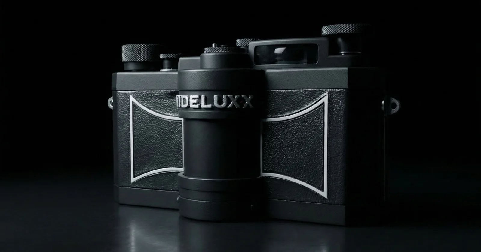 A black vintage-style camera labeled “DELUX” is shown against a dark background, with textured panels and metallic knobs visible in dramatic lighting.