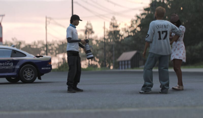 A photographer holding a large camera faces two people on a street near a parked racing car. The person on the right wears a "Legend 17" jersey, and the other person stands beside them in a floral dress. Trees and buildings are in the background.
