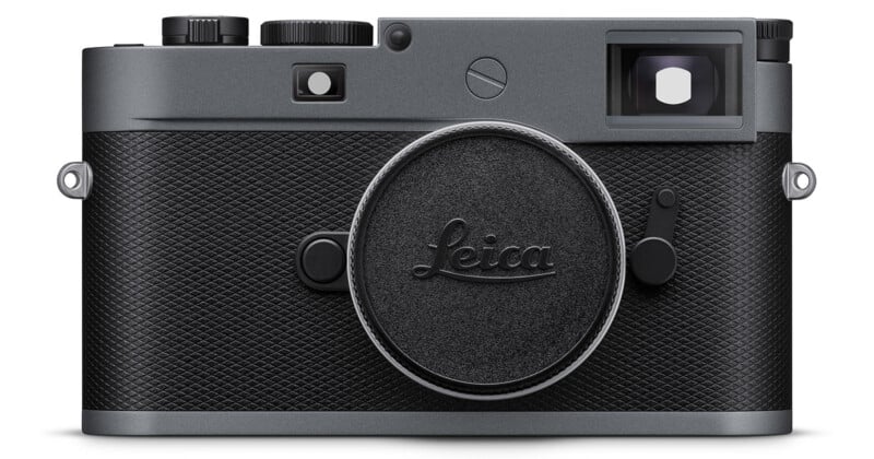 A front view of a black Leica rangefinder camera with textured grip, control dials, and the lens mount cap displaying the Leica logo.