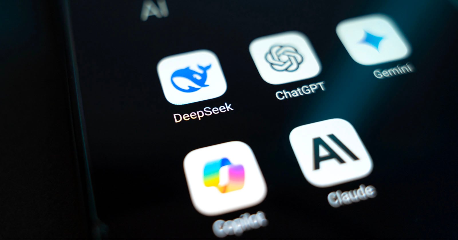 Close-up of a smartphone screen displaying app icons for DeepSeek, ChatGPT, Gemini, Copilot, Claude, and an AI-related app. The icons are clear with distinct logos and names visible.