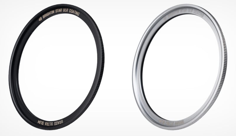 Two round camera lens filters, one black and one silver, are standing upright on a white background. Both filters have textured edges and engraved text along the rims.