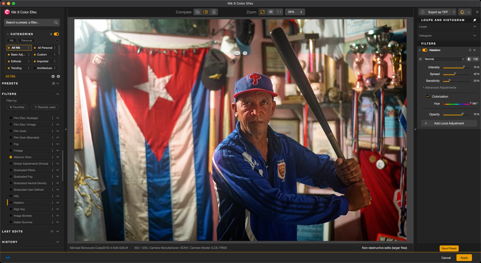 A man in a baseball cap and blue jacket holds a baseball bat in front of a Cuban flag. The Nik 9 Color Efex software interface is visible on the left and right.