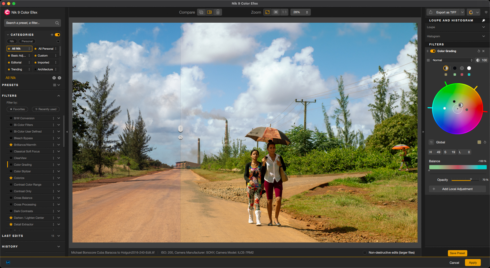 Editing software interface showing a photo of two people walking on a rural road, one holding an umbrella. The image is split to display a before-and-after color adjustment, with editing tools visible on the left and right panels.