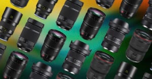 Multiple camera lenses of various sizes and brands are arranged diagonally on a vibrant, gradient background with green, yellow, and orange hues. The lenses are viewed from different angles.