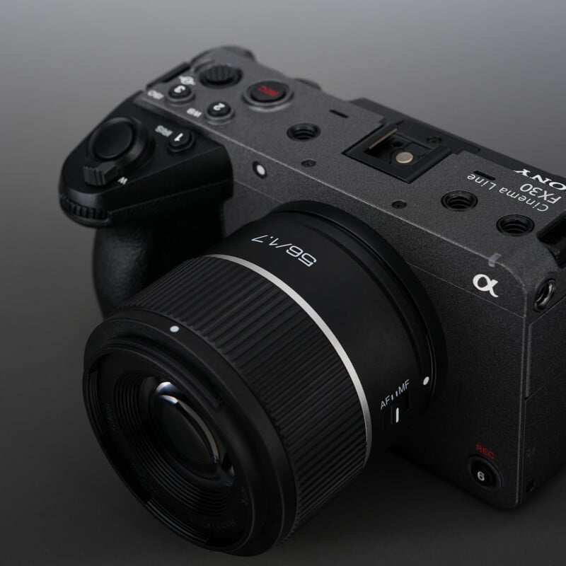A close-up view of a Sony FX30 cinema camera with a 16-55mm lens attached, shown against a dark gray background.