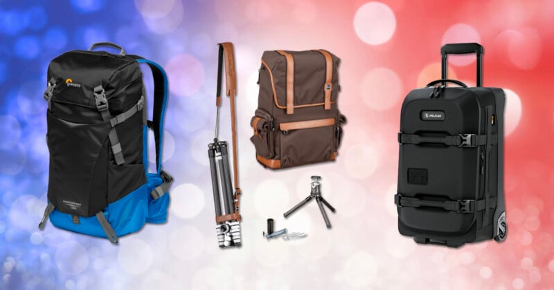 Three camera bags are displayed against a blurred red, white, and blue background. From left to right: a black and blue backpack, a brown shoulder bag with camera accessories, and a black rolling hard case.