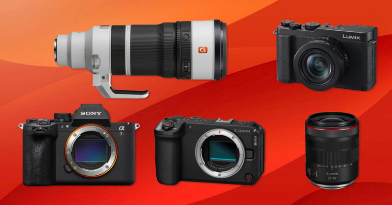 A selection of cameras and lenses displayed on a red and orange background, including Sony and Canon mirrorless cameras with their lenses detached, and a Panasonic Lumix camera with lens attached.