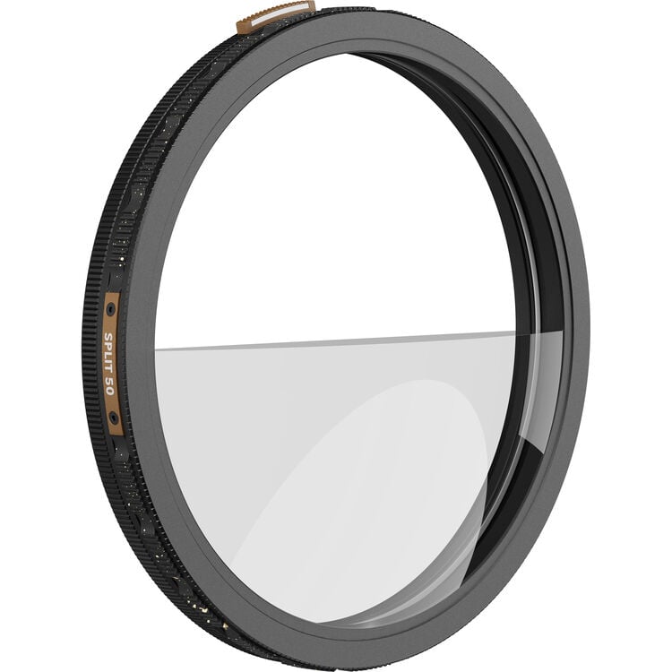 A round camera lens filter with a black metal frame and a half-clear, half-darkened split glass design, viewed at an angle against a white background.
