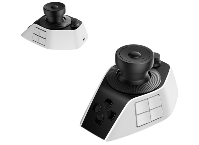 A white and black one-handed gaming controller with a large joystick, directional pad, multiple buttons on the front and side, and a USB-C port. The image shows two views of the controller.