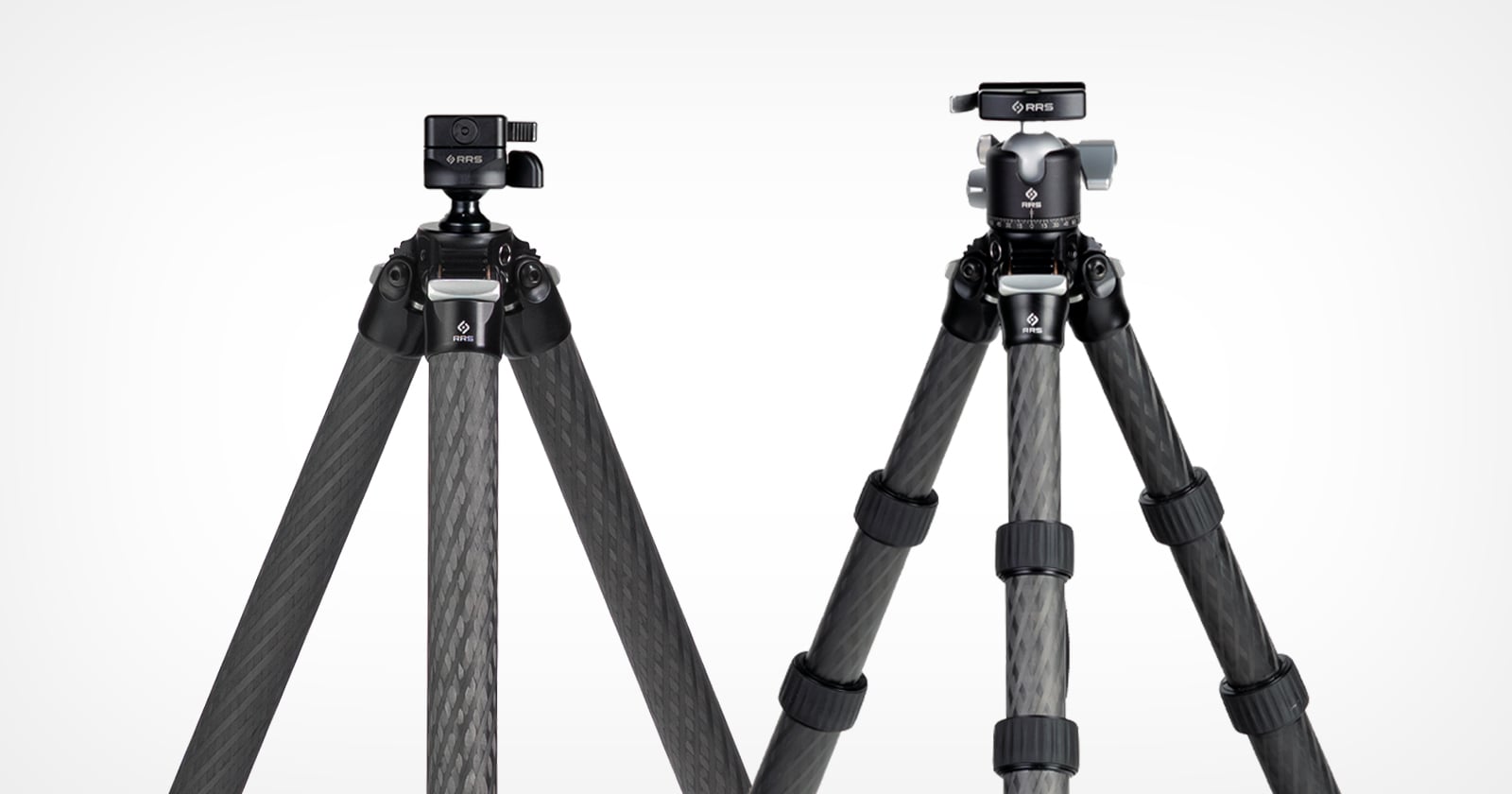 Two carbon fiber tripods with black legs are shown standing side by side against a white background. Each has a different style of tripod head mounted on top.