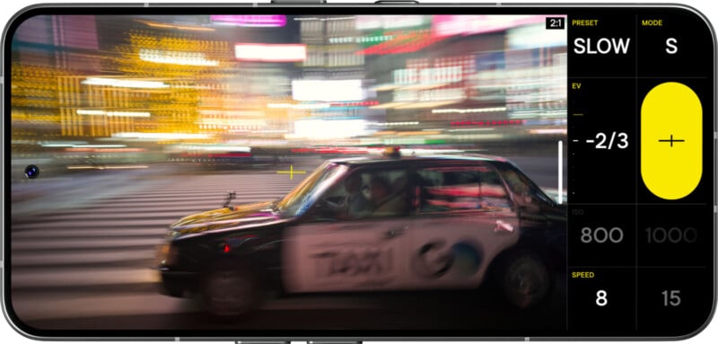 A smartphone screen displays a photo of a black taxi driving through a city at night, with bright, colorful lights blurred in the background to show motion. Camera settings are visible on the right side of the screen.