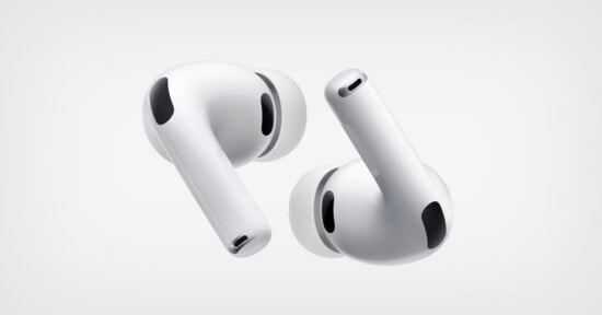 Two white wireless earbuds with silicone ear tips are shown against a plain light background, positioned at different angles to display their sleek design and black vent details.
