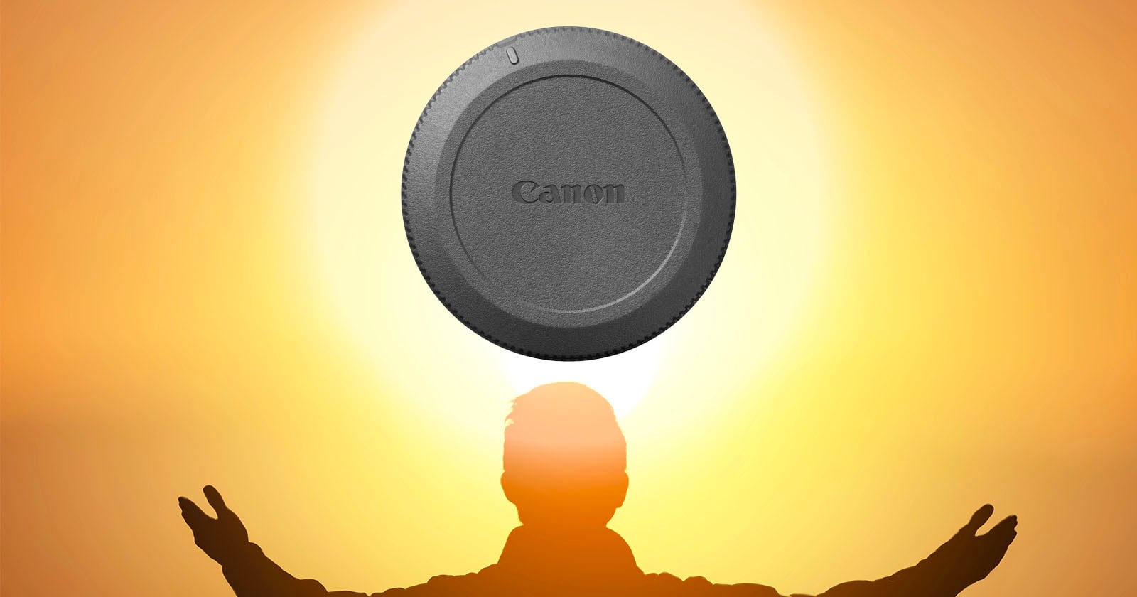 A silhouette of a person with arms raised stands in front of a glowing orange sky, with a Canon lens cap positioned above their head, resembling a halo or the sun.