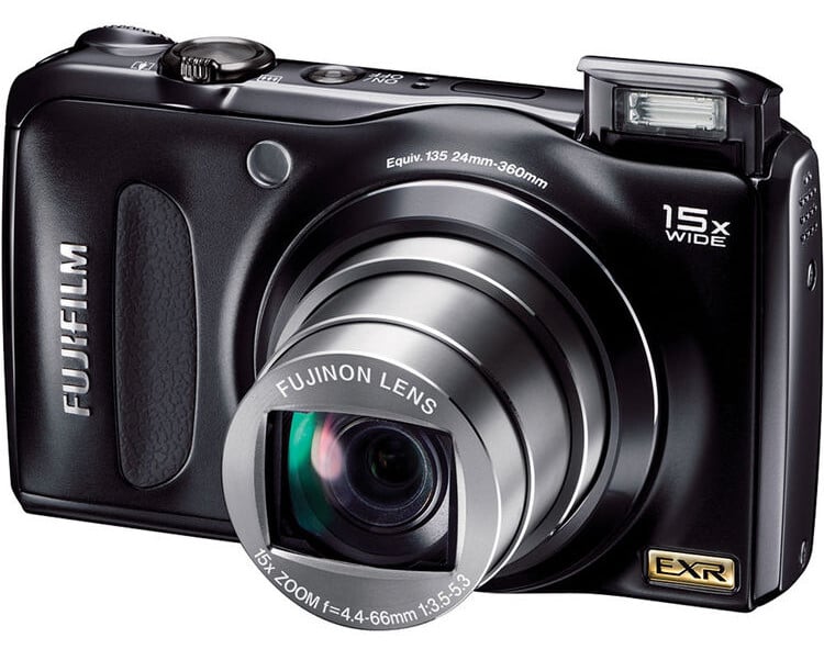 A black Fujifilm digital camera with a protruding lens, pop-up flash, and 15x wide zoom, shown from a front angle with the brand and lens details visible.