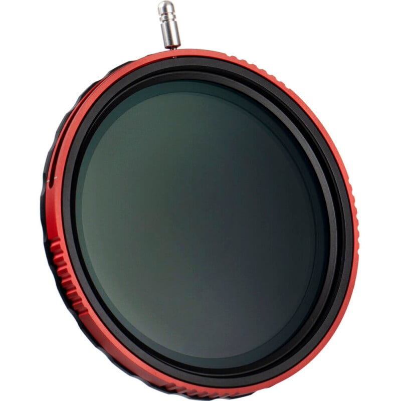 A close-up of a circular camera lens filter with a red metal frame, dark glass center, and a small silver screw or knob at the top. The filter is angled slightly against a white background.
