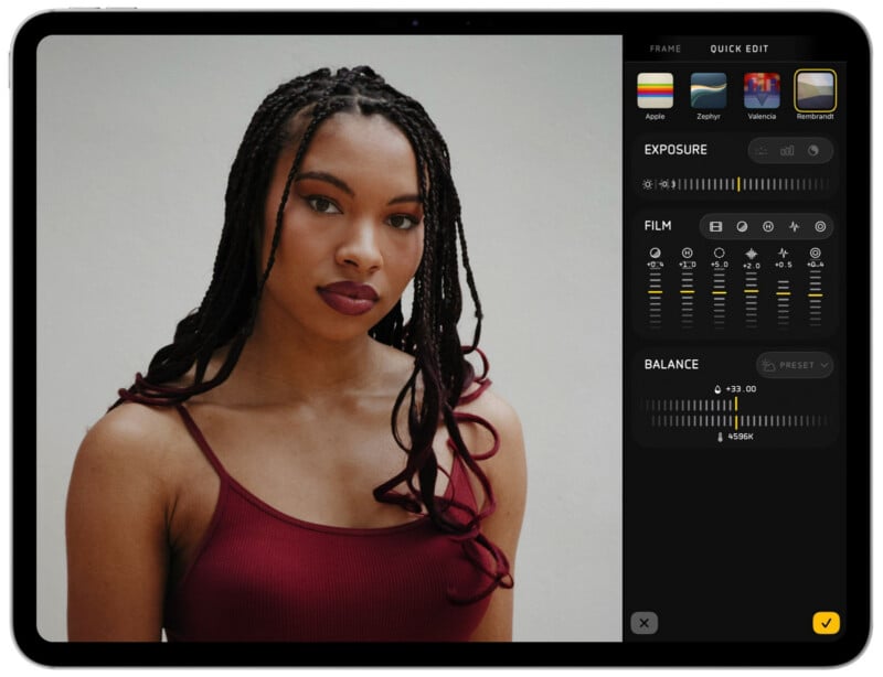 A tablet screen displays a photo of a woman with long braided hair and a burgundy tank top. Editing options for exposure, film, and color balance are visible on the right side of the screen.