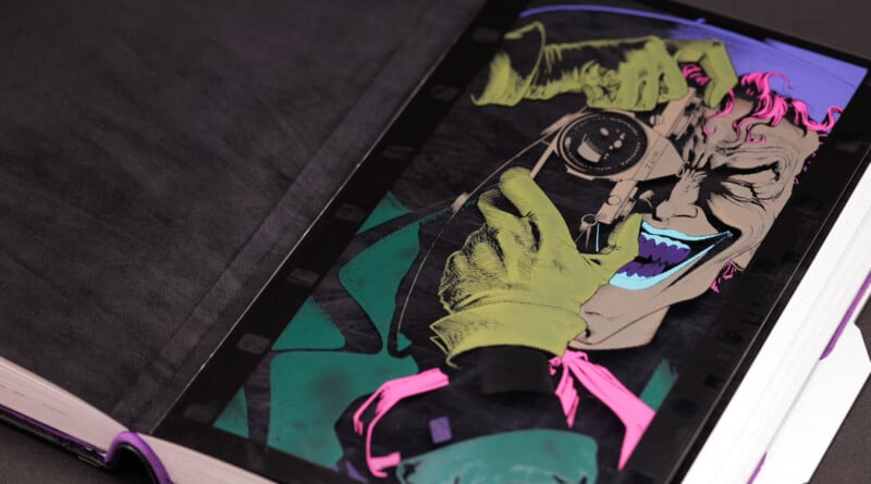An illustrated comic book page shows a grinning character with green gloves and pink hair aiming a camera directly at the viewer, set against a dark background.